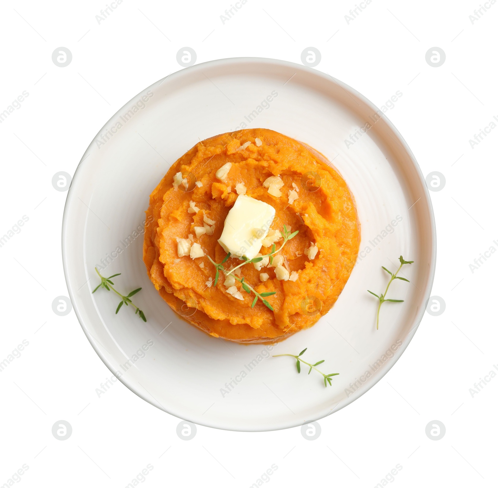 Photo of Plate with tasty mashed sweet potato, butter, thyme and walnuts isolated on white, top view