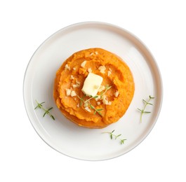 Photo of Plate with tasty mashed sweet potato, butter, thyme and walnuts isolated on white, top view