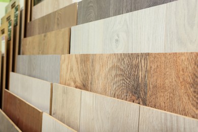 Photo of Many different samples of wooden flooring in store, closeup