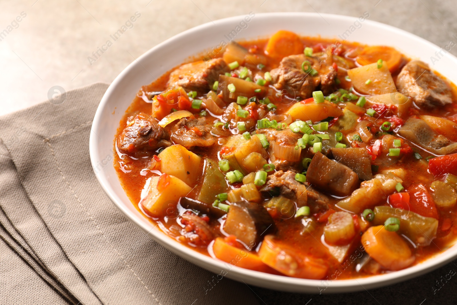 Photo of Delicious stew with vegetables in bowl on table, closeup