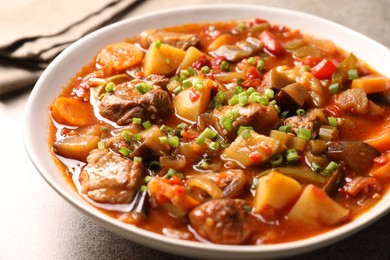 Photo of Delicious stew with vegetables in bowl on table, closeup