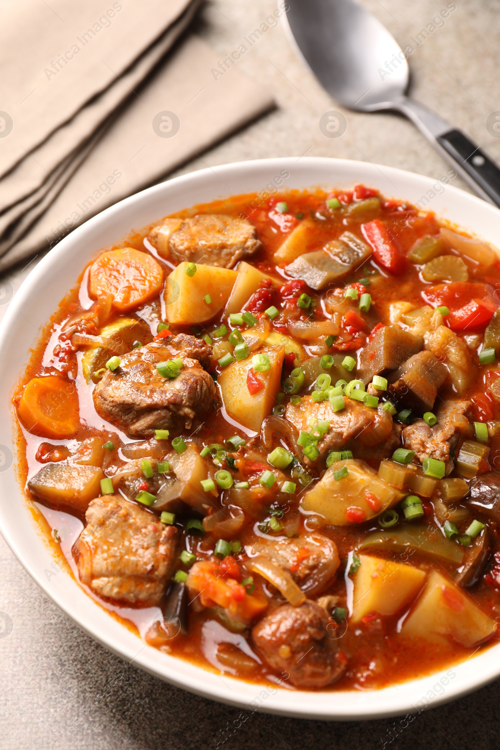 Photo of Delicious stew with vegetables in bowl on table, closeup