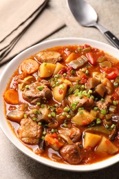 Photo of Delicious stew with vegetables in bowl on table, closeup