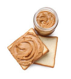 Photo of Peanut butter in jar and pieces of bread isolated on white, top view