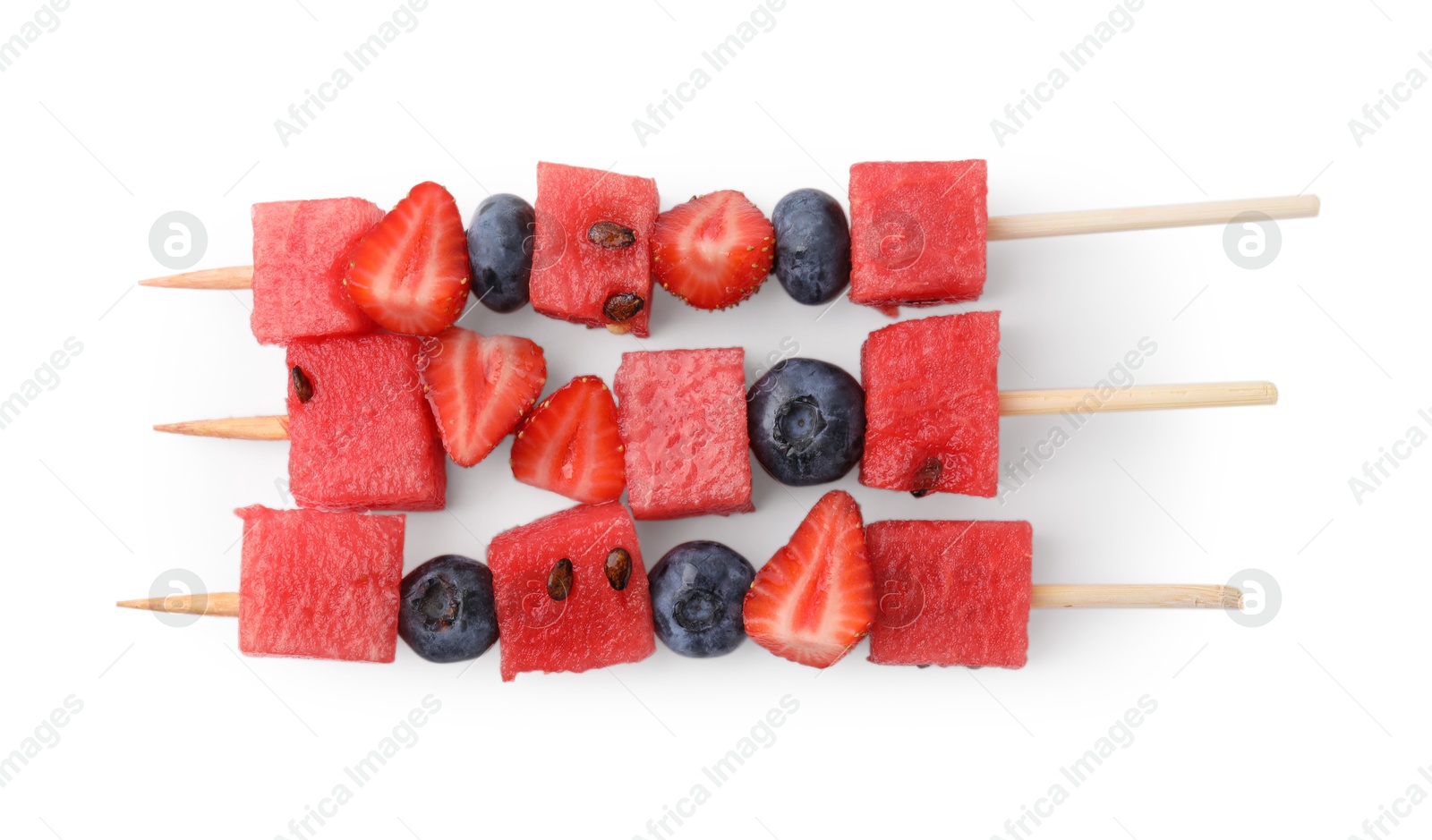 Photo of Skewers with tasty watermelon, blueberries and strawberries isolated on white, top view