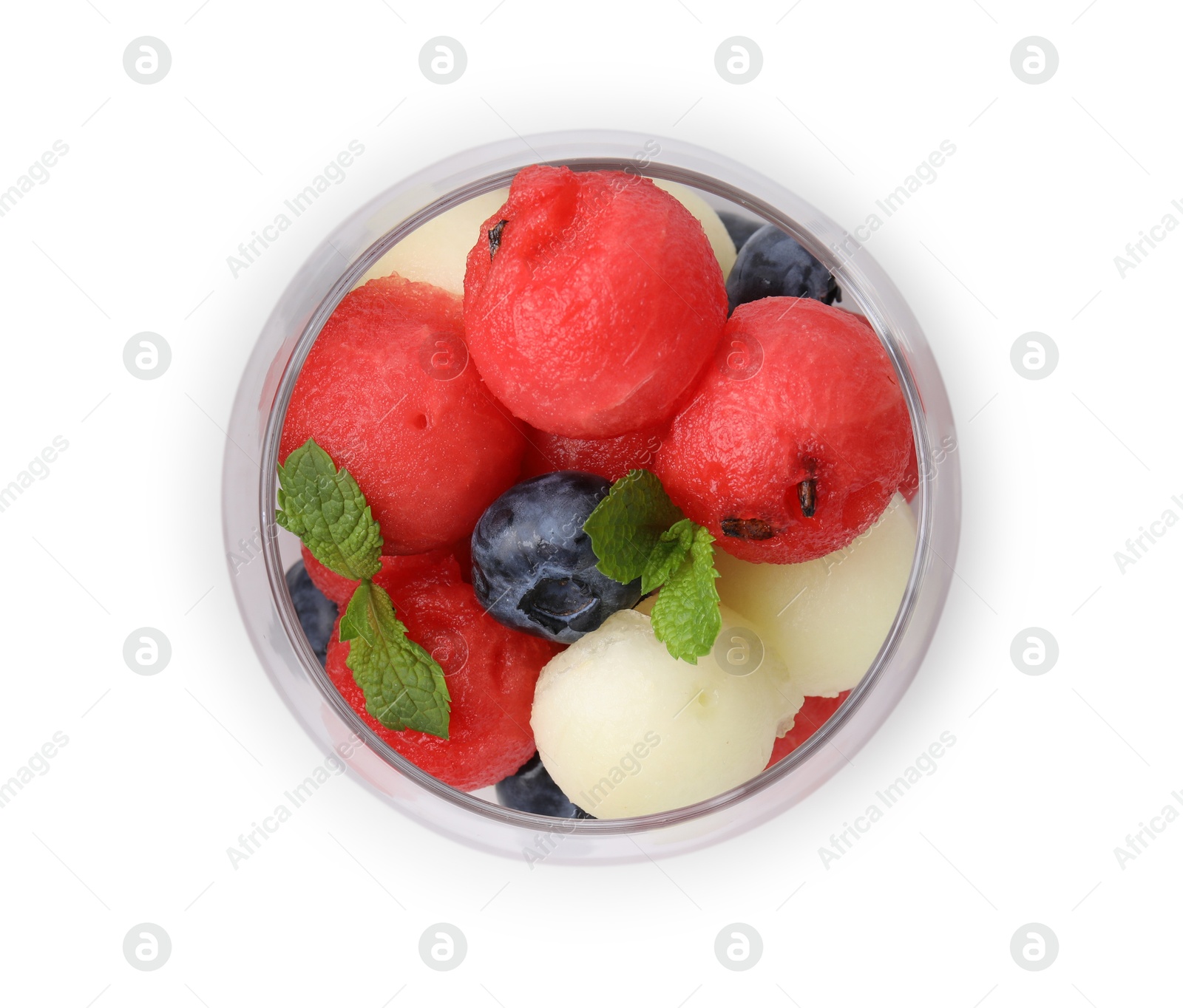 Photo of Tasty watermelon and melon balls with blueberries in glass isolated on white, top view