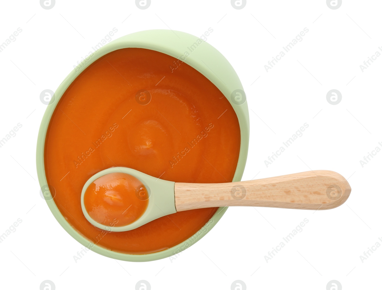 Photo of Tasty baby food in bowl and spoon isolated on white, top view