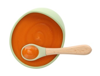 Photo of Tasty baby food in bowl and spoon isolated on white, top view