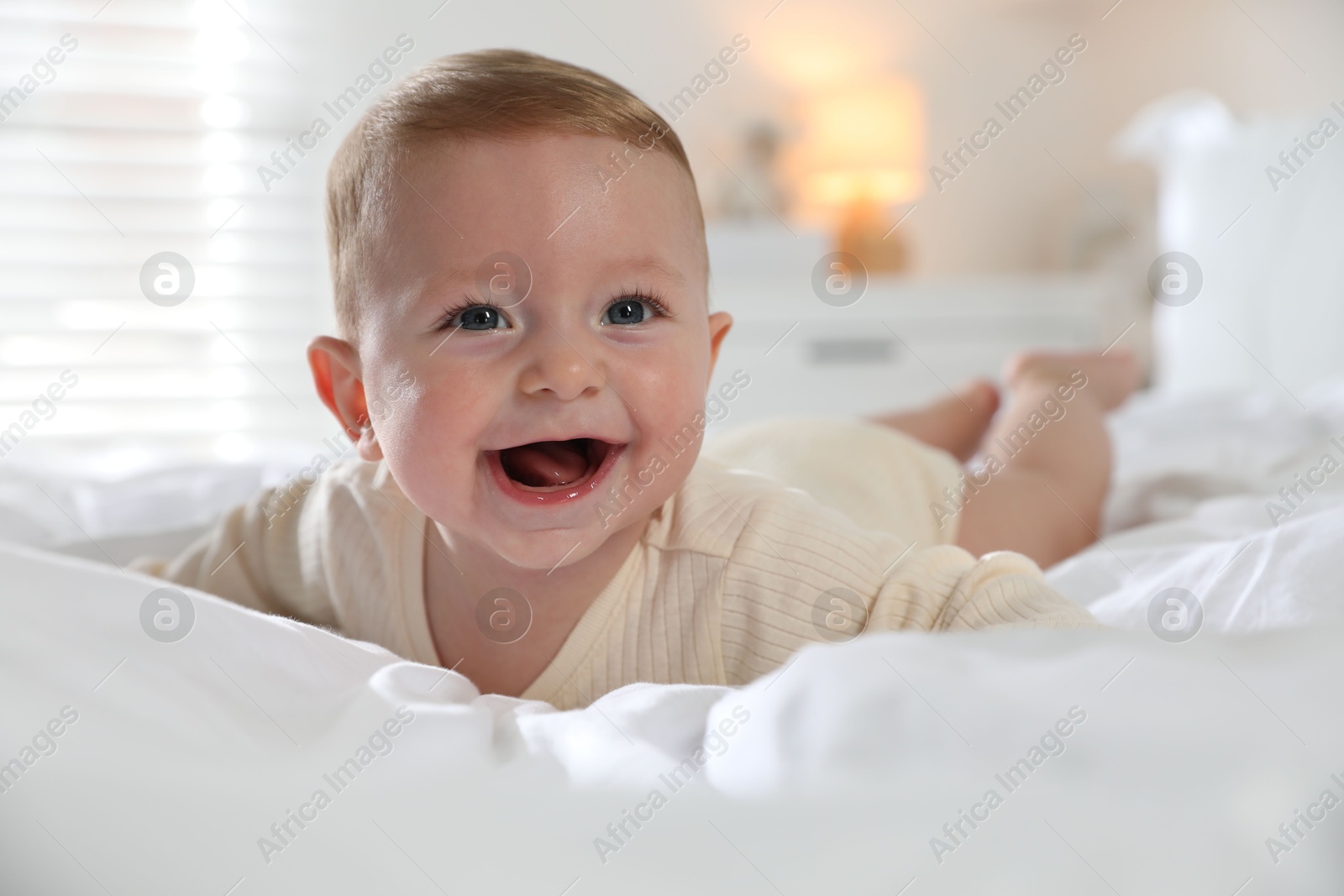 Photo of Cute little baby on bed at home