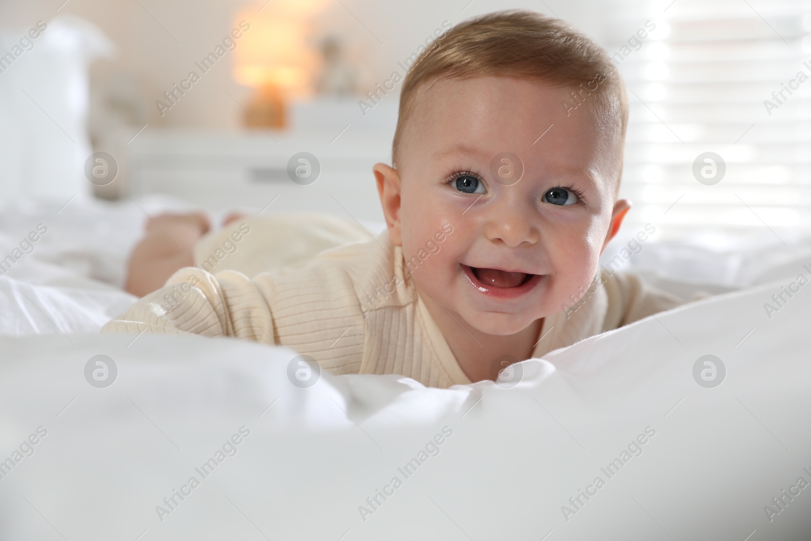 Photo of Cute little baby on bed at home