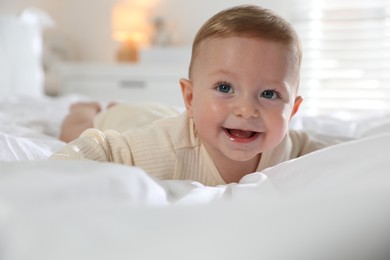 Cute little baby on bed at home