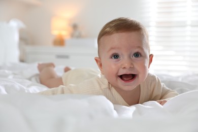 Photo of Cute little baby on bed at home