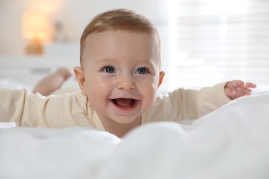 Photo of Cute little baby on bed at home