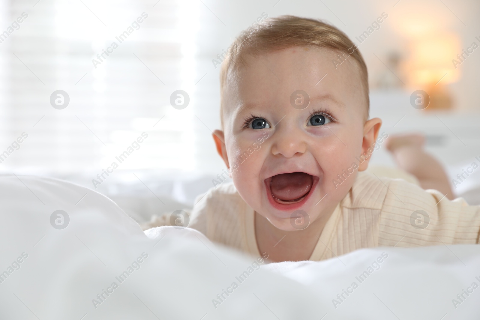 Photo of Cute little baby on bed at home