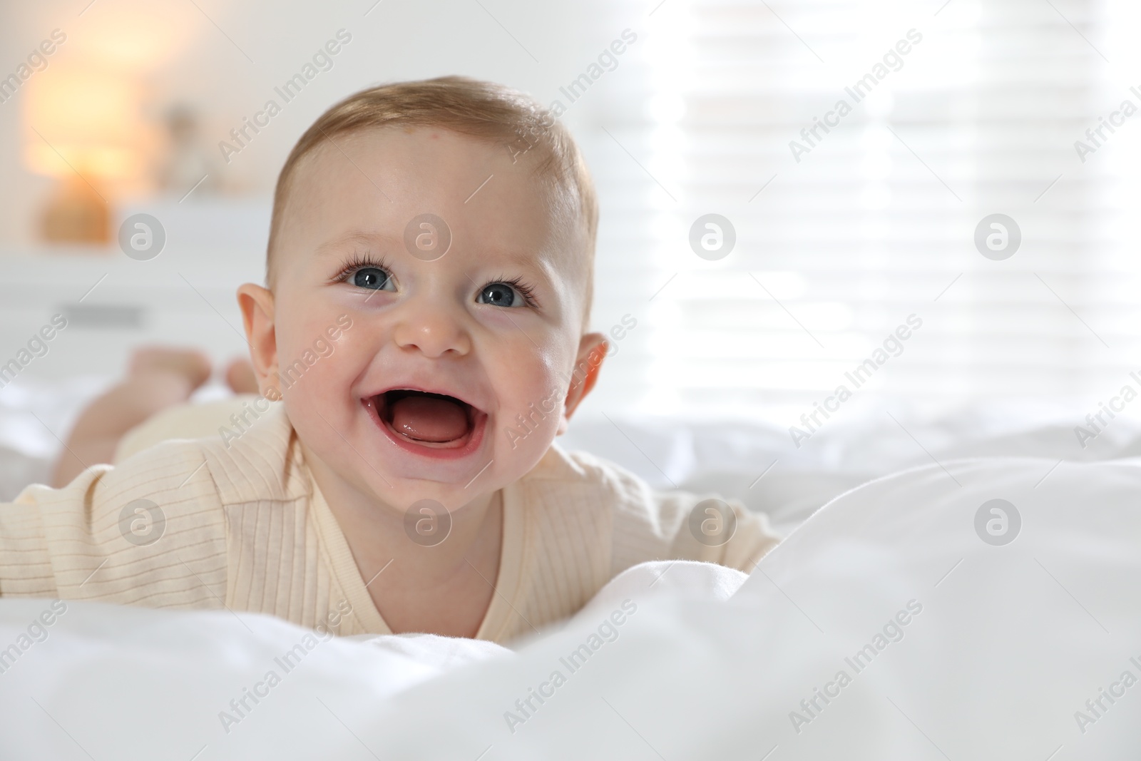 Photo of Cute little baby on bed at home