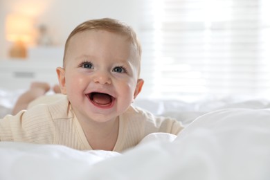 Photo of Cute little baby on bed at home