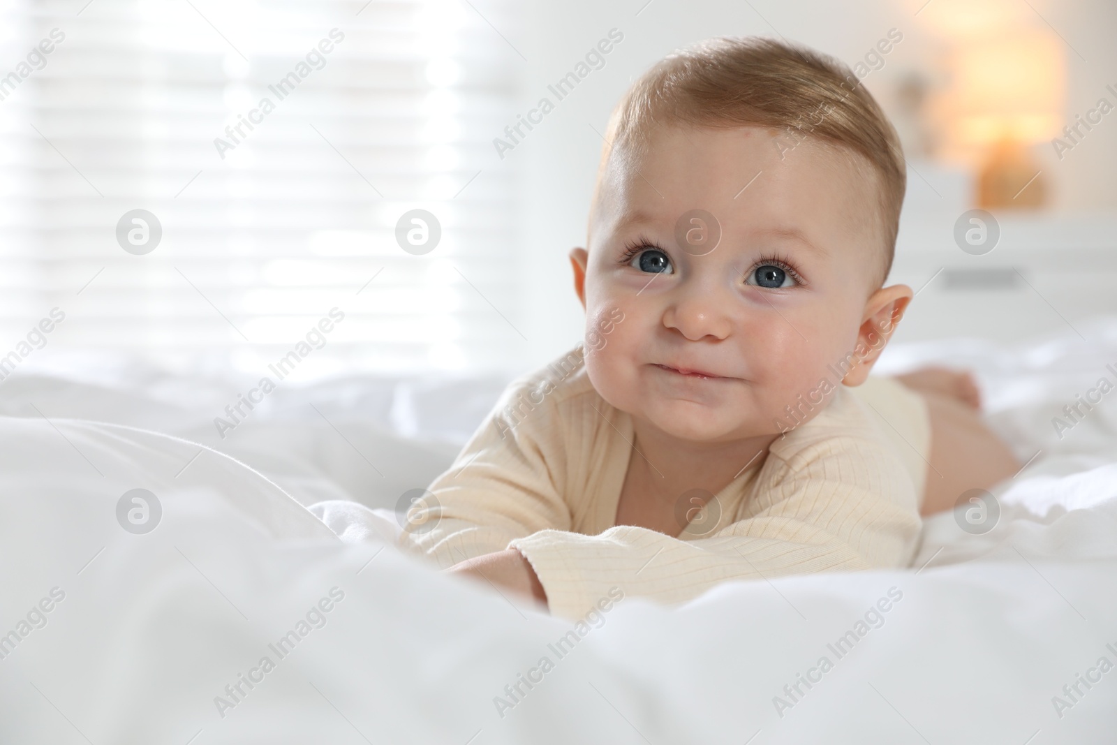 Photo of Cute little baby on bed at home