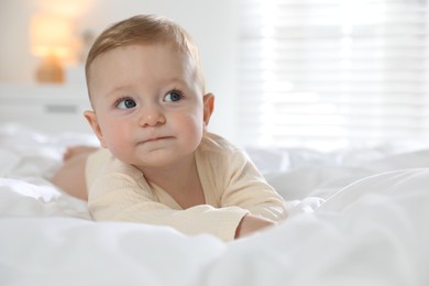 Cute little baby on bed at home