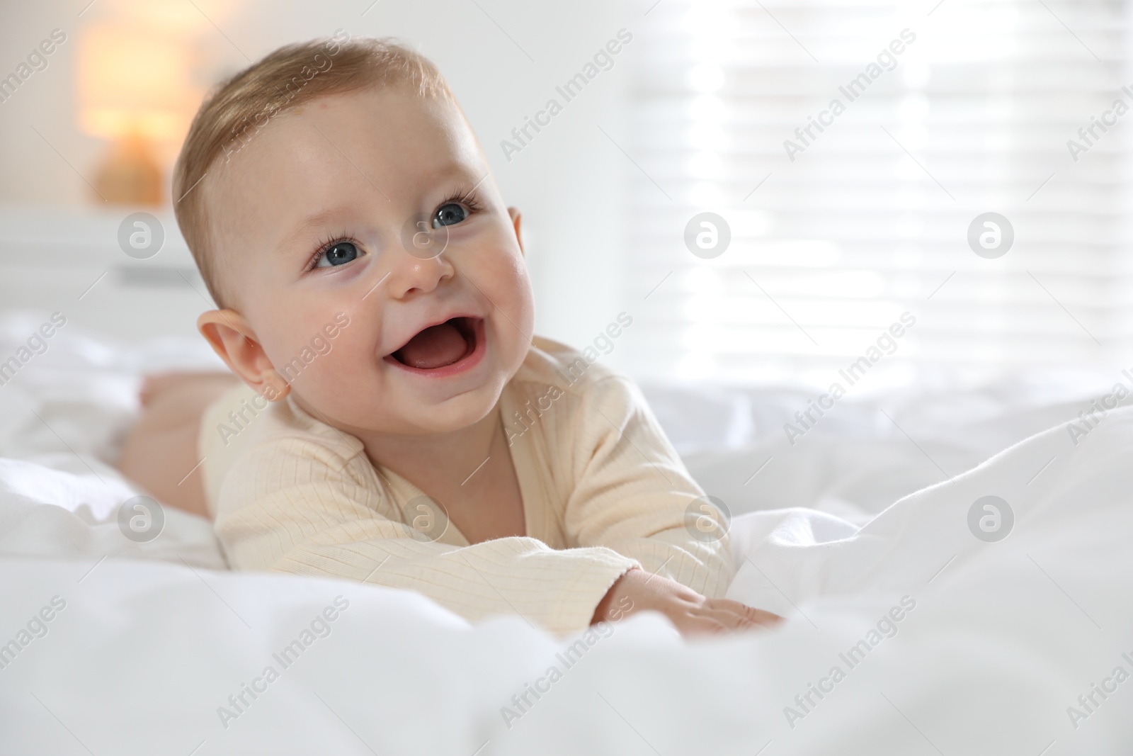 Photo of Cute little baby on bed at home