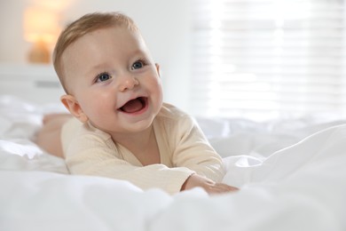 Photo of Cute little baby on bed at home