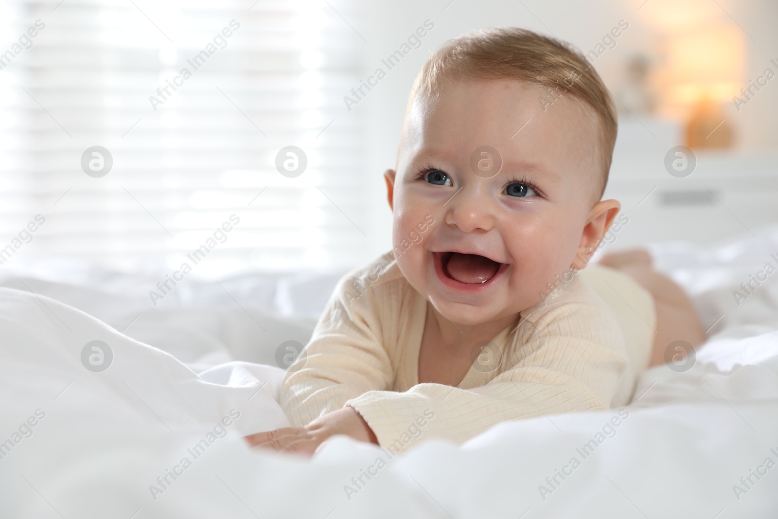 Photo of Cute little baby on bed at home