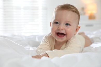 Photo of Cute little baby on bed at home