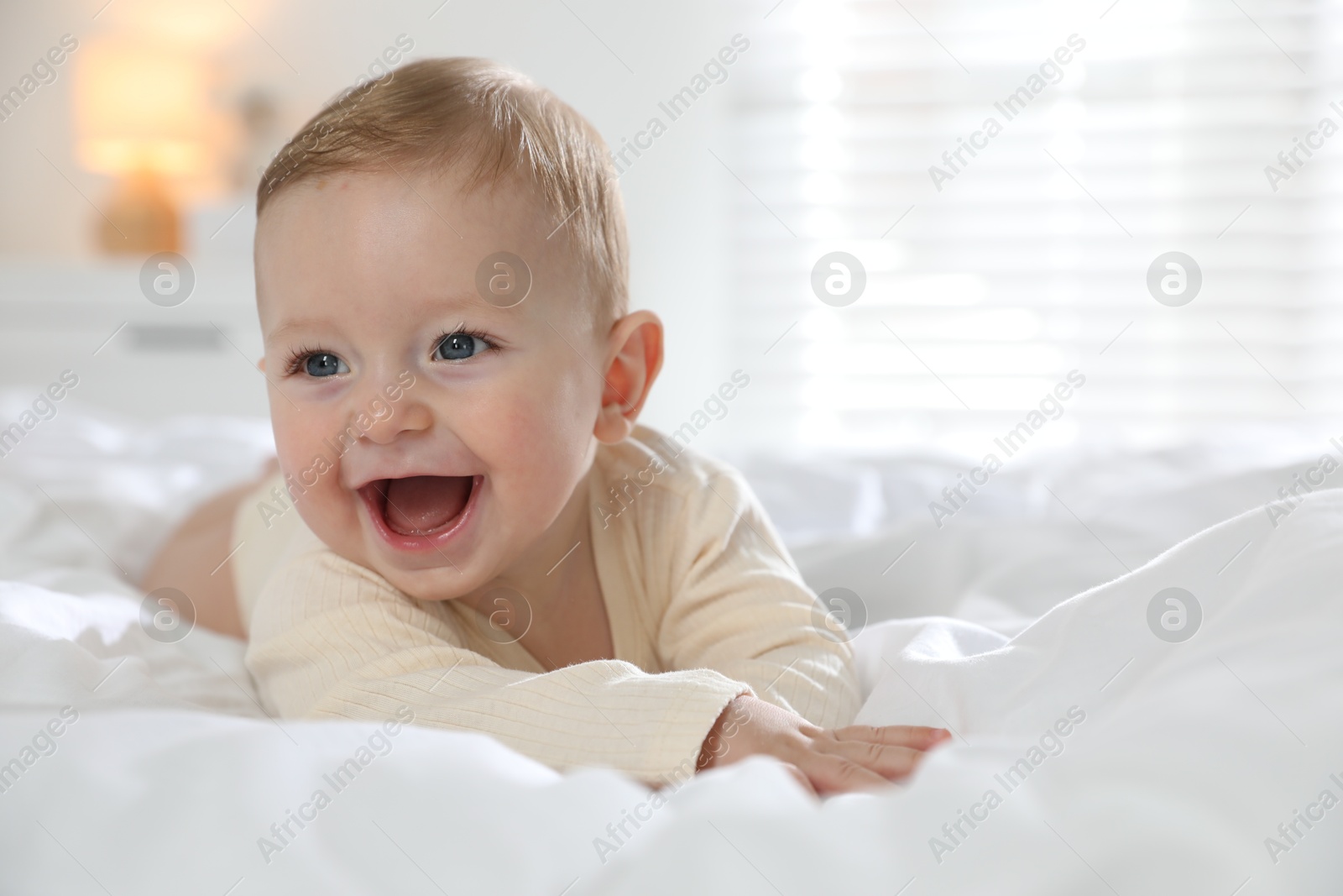 Photo of Cute little baby on bed at home