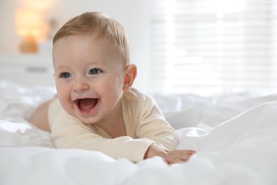 Cute little baby on bed at home