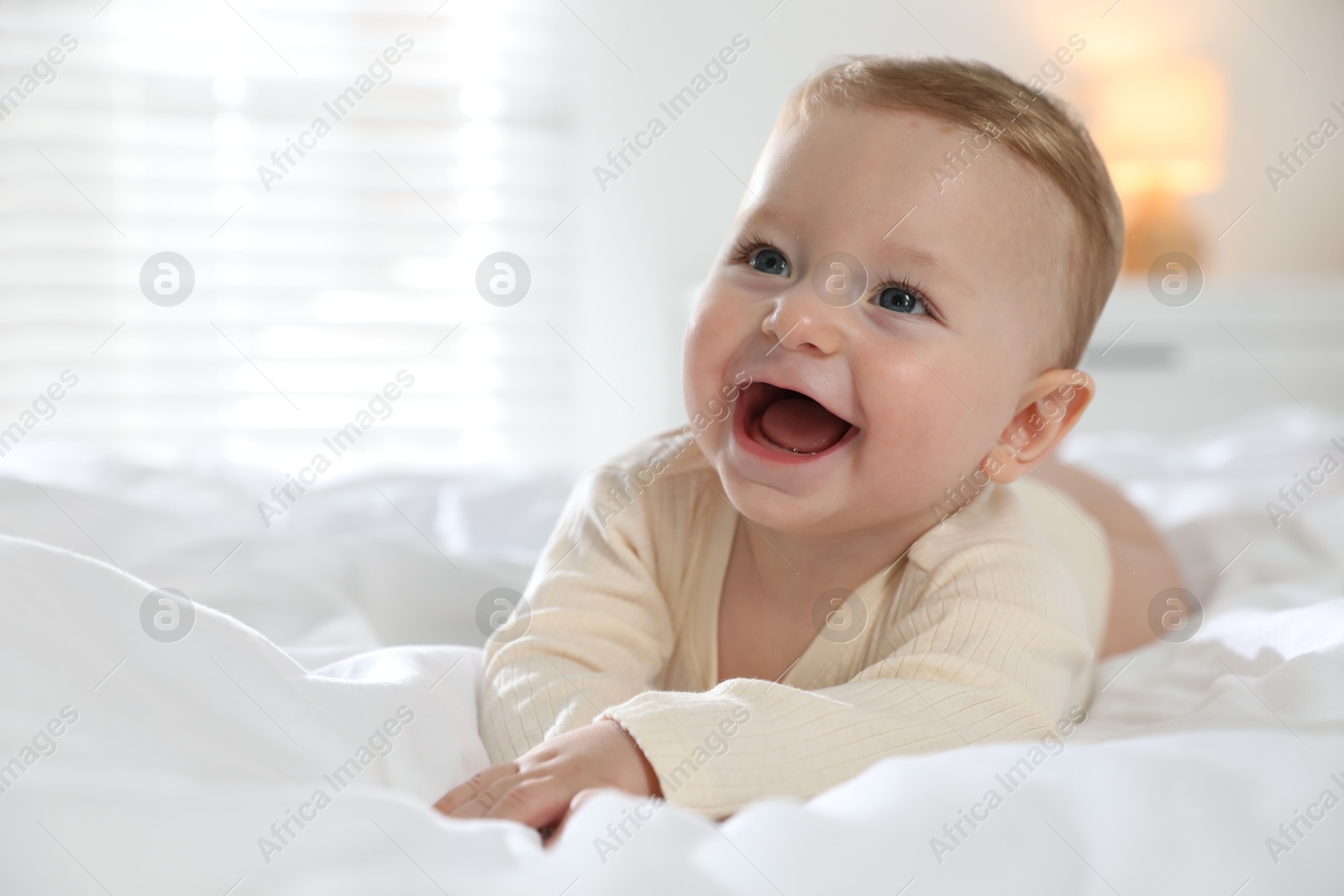 Photo of Cute little baby on bed at home