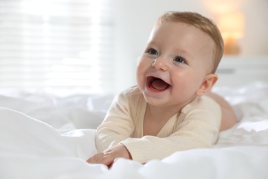 Cute little baby on bed at home