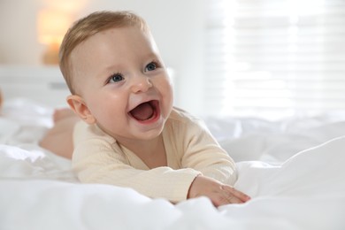 Photo of Cute little baby on bed at home