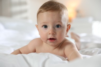 Cute little baby on bed at home