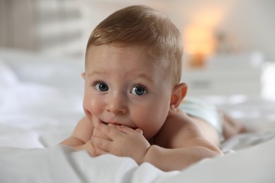 Cute little baby on bed at home