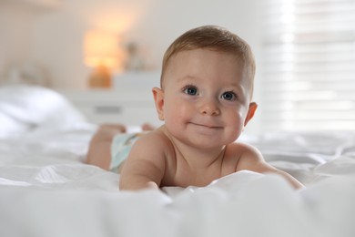 Cute little baby on bed at home