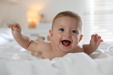 Cute little baby on bed at home