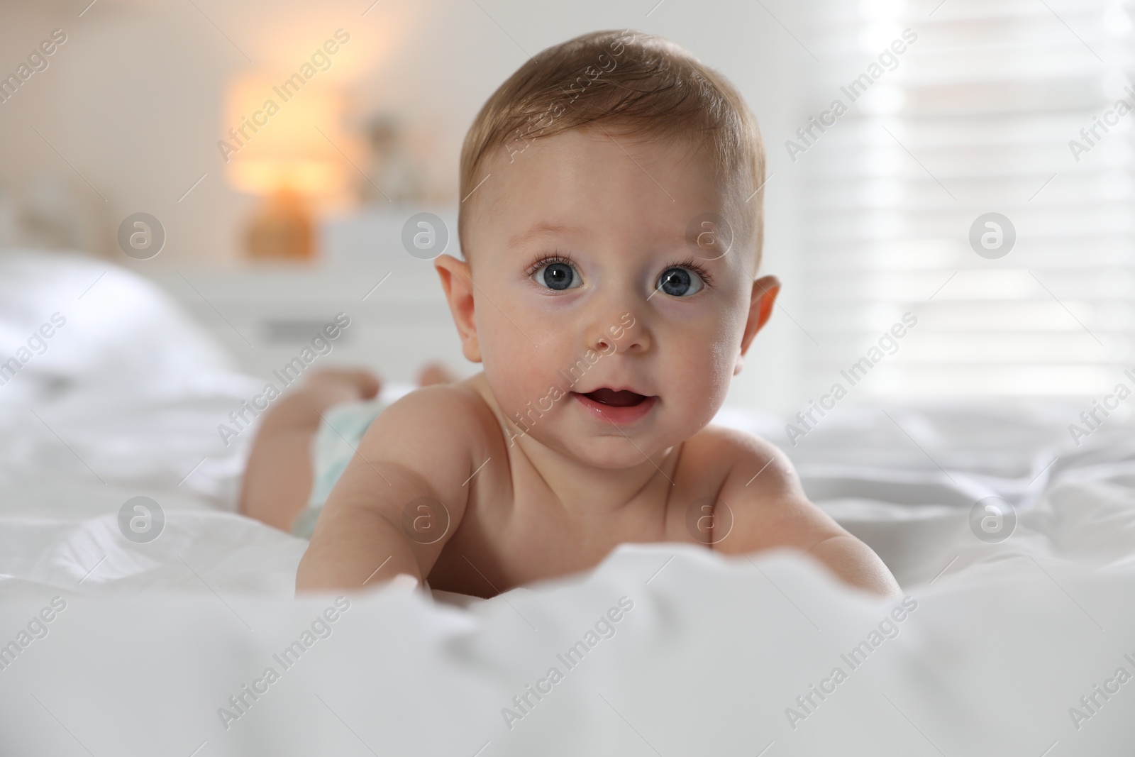 Photo of Cute little baby on bed at home