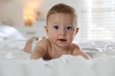 Cute little baby on bed at home