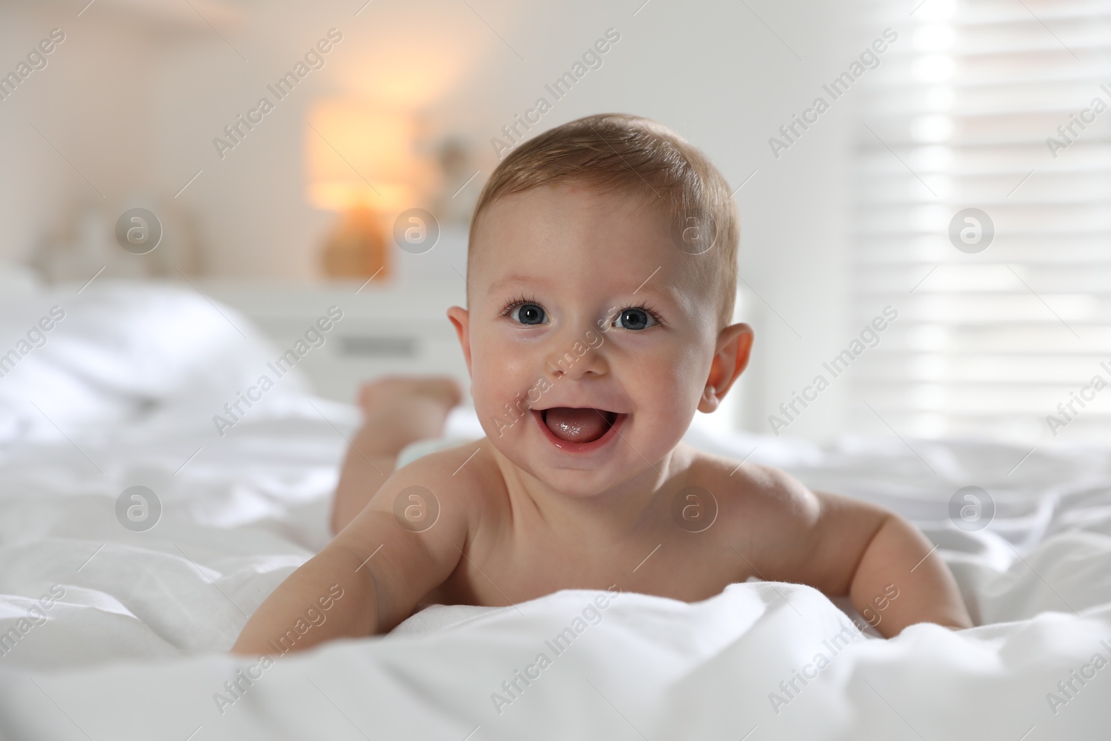 Photo of Cute little baby on bed at home