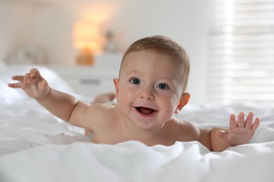 Cute little baby on bed at home