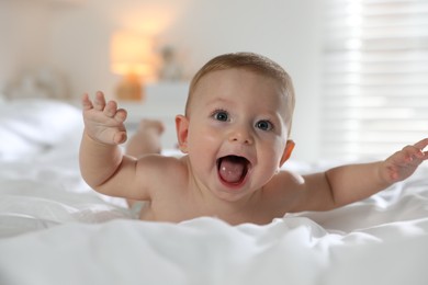 Cute little baby on bed at home