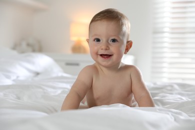 Photo of Cute little baby on bed at home