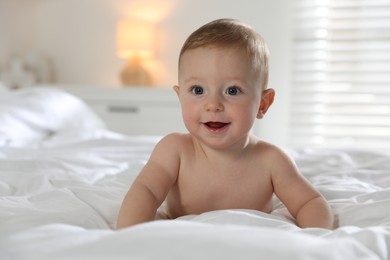 Cute little baby on bed at home