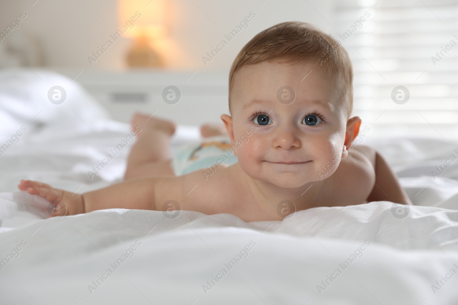 Photo of Cute little baby on bed at home