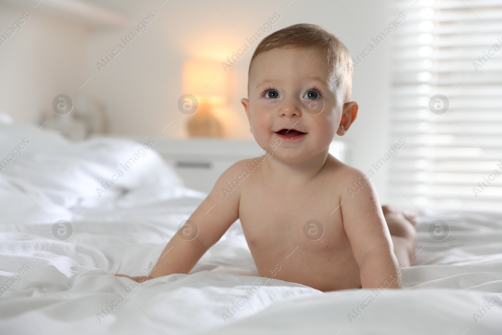 Photo of Cute little baby on bed at home