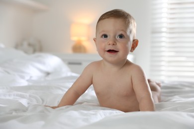 Cute little baby on bed at home