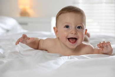 Photo of Cute little baby on bed at home