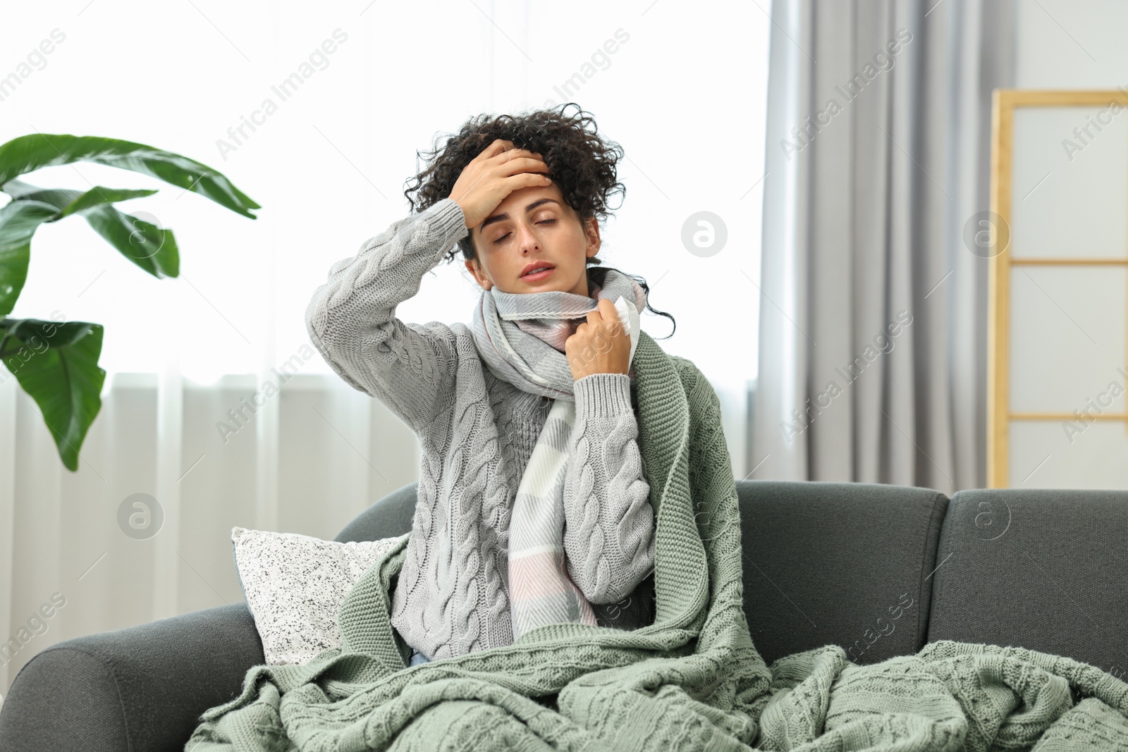 Photo of Cold symptom. Young woman with tissue at home