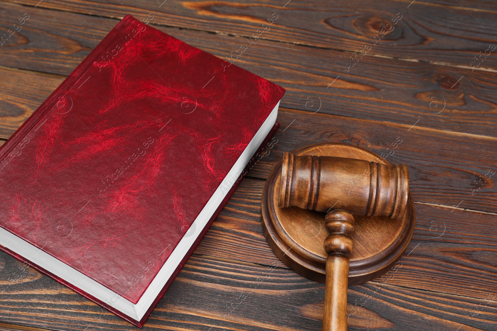 Photo of Book and judge's gavel on wooden table