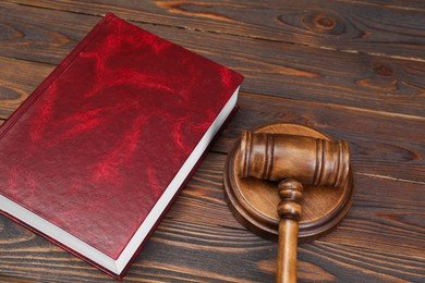 Photo of Book and judge's gavel on wooden table