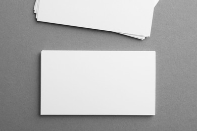 Blank business cards on grey background, top view. Mockup for design